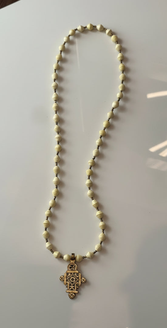 Necklace with beads and a decorative clasp on a white background