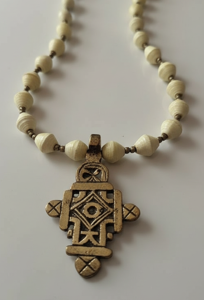 Necklace with a decorative pendant on a plain background