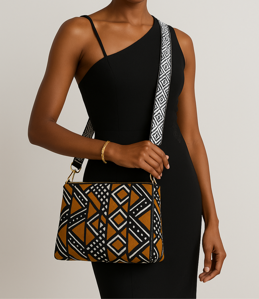 This image features a stylish crossbody bag with a distinctive geometric pattern. The bag displays a complex design in shades of black, beige, and brown, giving it a modern and trendy look.
