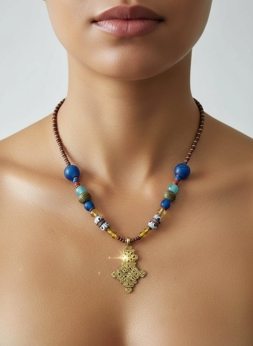 Necklace with colorful beads and a gold pendant on a neutral background